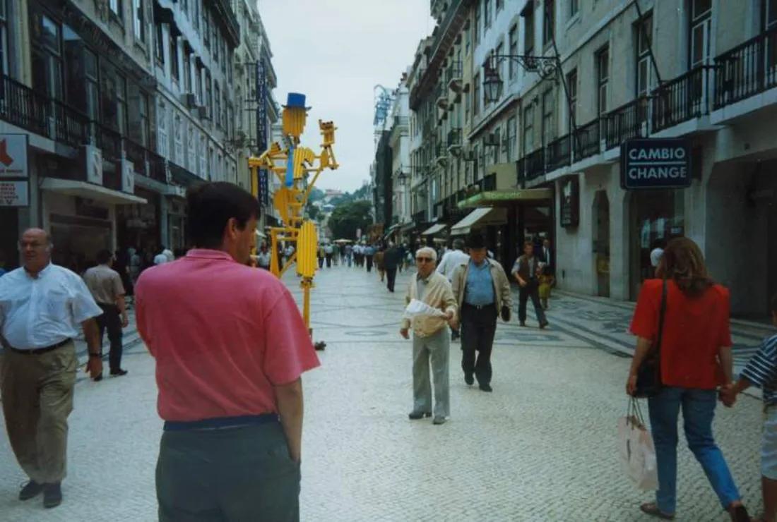 people walking through a real street in Lisbon